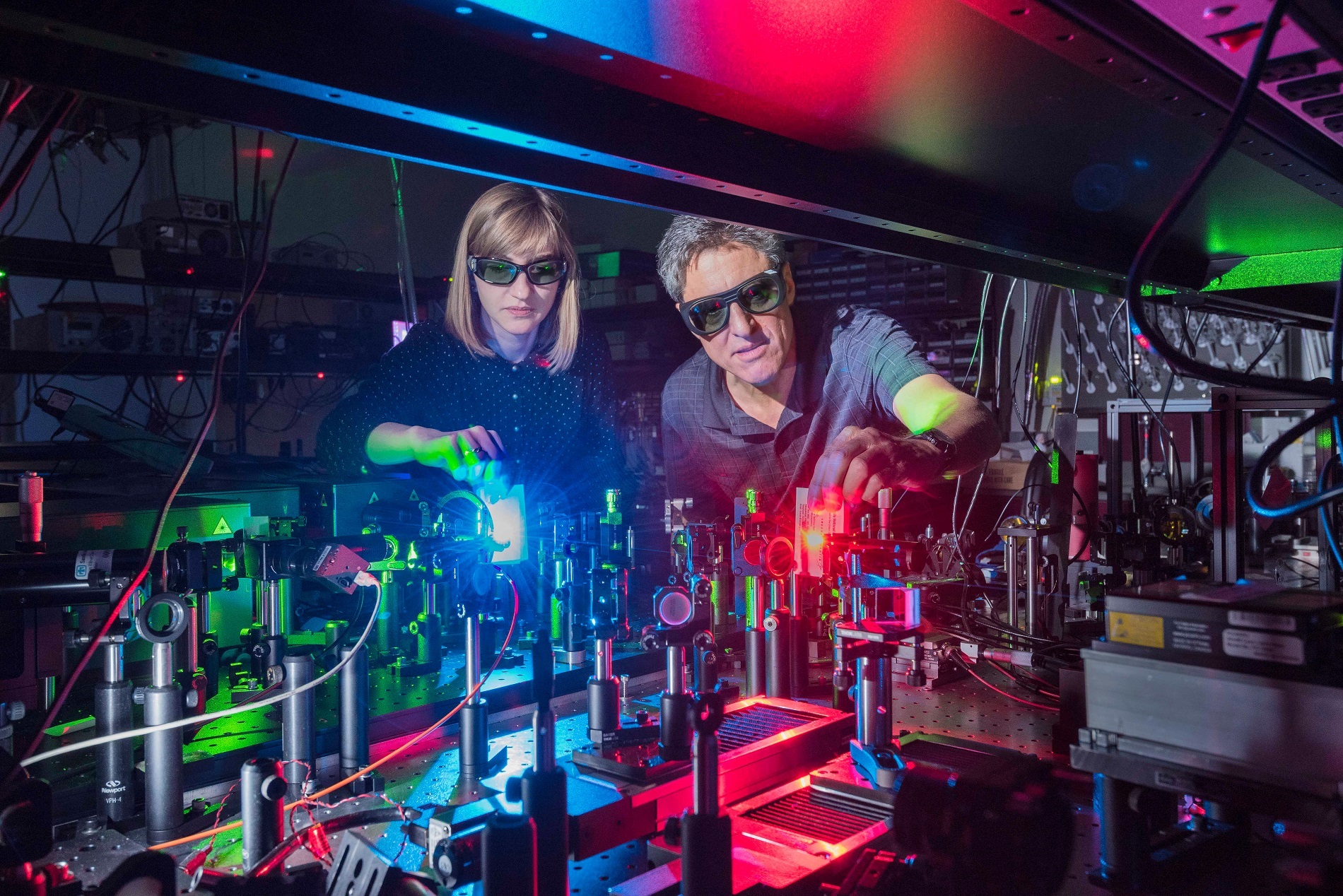 Sandia National Laboratories postdoctoral appointee Polina Vabishchevich, left; and Senior Scientist Igal Brener made a metamaterial that mixes two lasers to produce 11 colors ranging from the near infrared, through the colors of the rainbow, to ultraviolet