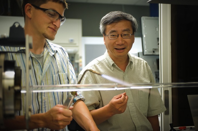 Liang Dong, right, works in a lab