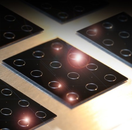 A silicon wafter with optical resonators, each capable of recirculating photons hundreds of thousands of times to generate specific optical freequencies