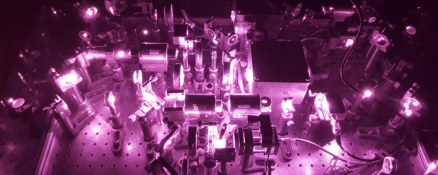 A photograph of an infrared optical tweezers device. Normally, the light from such lasers would be invisible to the naked eye.