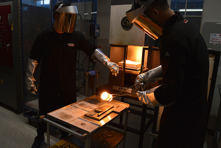 Ye Luo, doctoral student in materials science and engineering at Penn State, pours the new composition of germanosilicate glass into a form