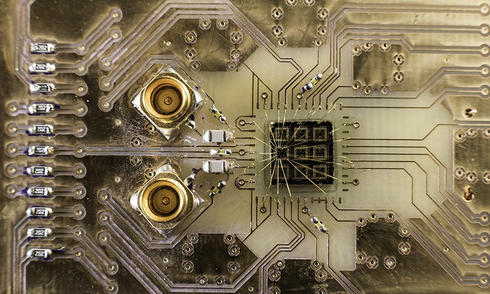 A quantum processor semiconductor chip is connected to a circuit board in the lab of John Nichol, an assistant professor of physics at the University of Rochester