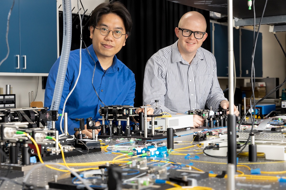 From left, Hsuan-Hao Lu and Joseph Lukens work in an ORNL quantum laboratory.
