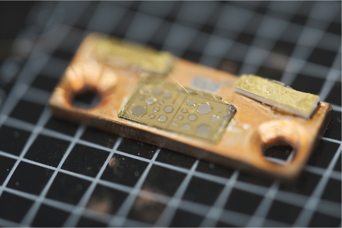 The chip with the hexagon-shaped laser cavities.