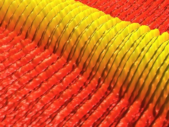 This atomic force microscope image shows directed self-assembly of a printed line of block copolymer on a template prepared by photolithography