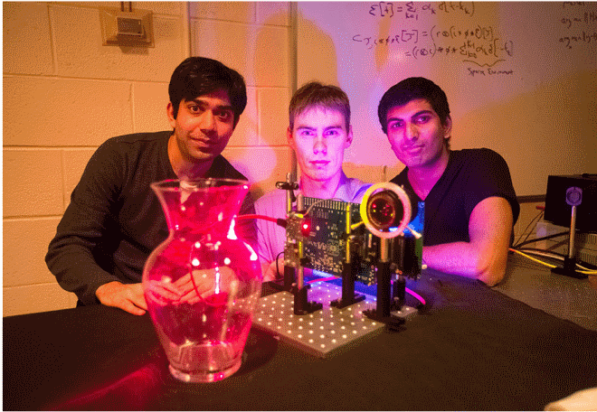 MIT students Ayush Bhandari, Refael Whyte and Achuta Kadambi pose next to their "nano-camera" that can capture translucent objects, such as a glass vase, in 3-D.