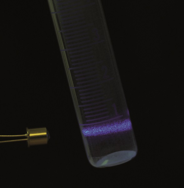 Blue fluorescent liquid emission through lighting with UV point source