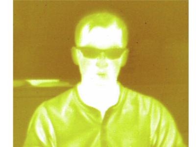 A thermal image of University of Arizona researcher Jared Griebel taken through a piece of new sulfur-based plastic using an infrared camera
