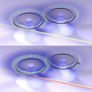 Loss-induced onset of lasing in coupled microresonators