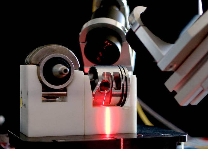 A line laser projects its light onto the ring and its surroundings