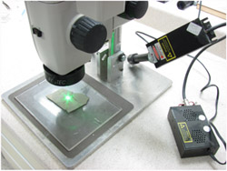 A green laser mounted on a stereo microscope