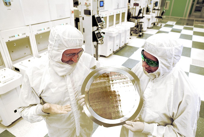 Researchers inspect a wafer comprised of 7nm node test chips in a clean room in Albany