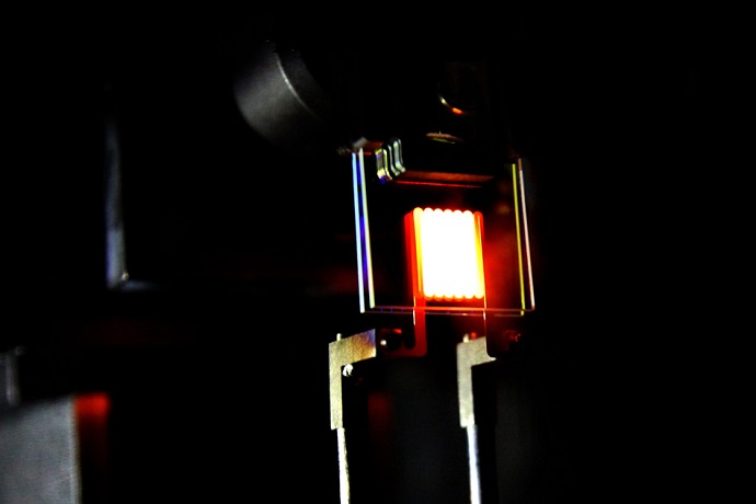A proof-of-concept device built by MIT researchers demonstrates the principle of a two-stage process to make incandescent bulbs more efficient