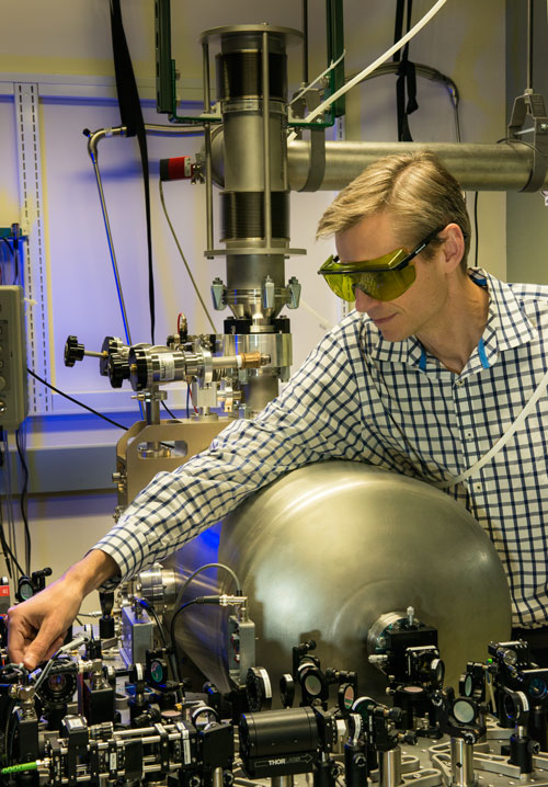 Konrad Lehnert with the cryogenic enclosure and lab setup for the quantum information converter