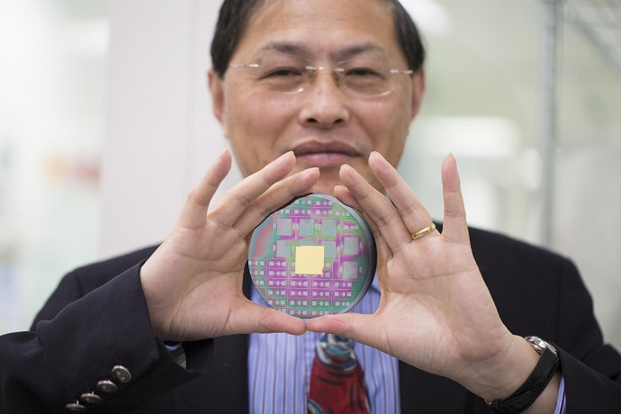 RMIT's Professor Min Gu with the breakthrough nanophotonic chip that can harness the angular momentum of light