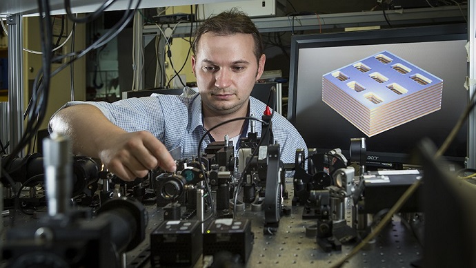 Dr Kruk next to a diagram of the metamaterial structure