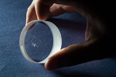 PML researcher Gordon Shaw holding a prototype for the chip-sized small-force meter