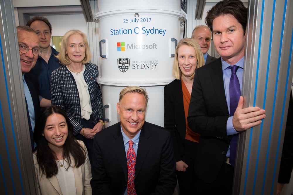 In front of one of the new specialist dilution refrigerators before the ceremonial signing.