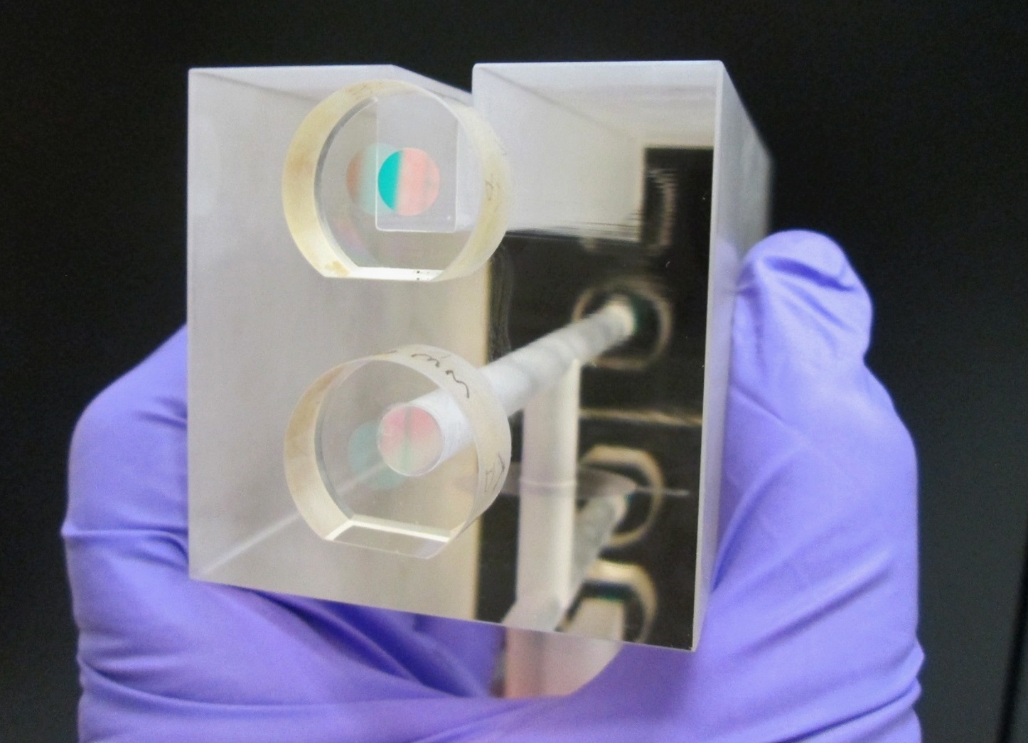 A NIST researcher holds a fixed length optical cavity