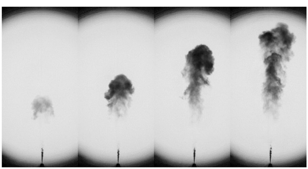Time sequence of images in a Sandia National Laboratories project that shows the extinction of light caused by a soot cloud formed during the injection of a diesel spray