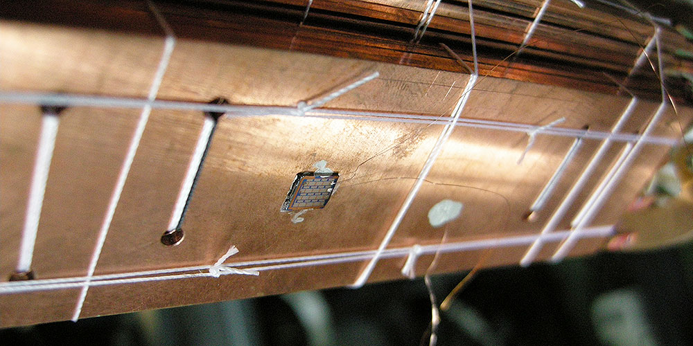 A chip with a Coulomb blockade thermometer on it is prepared for experiments at extremely low temperatures