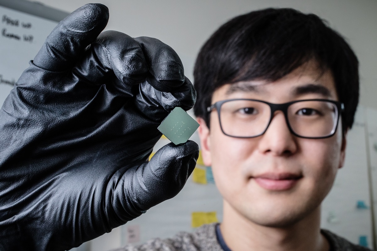 Illinois mechanical science and engineering student and lead author of a new study Benjamin Sohn holds a device that uses sound waves to produce optical diodes tiny enough to fit onto a computer chip
