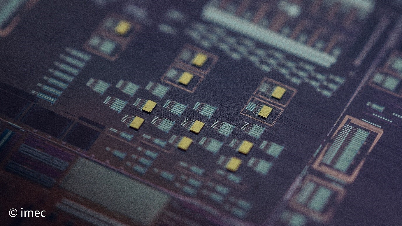 Picture of IMEC 300 mm Si photonic wafer with InP laser dies bonded on top.