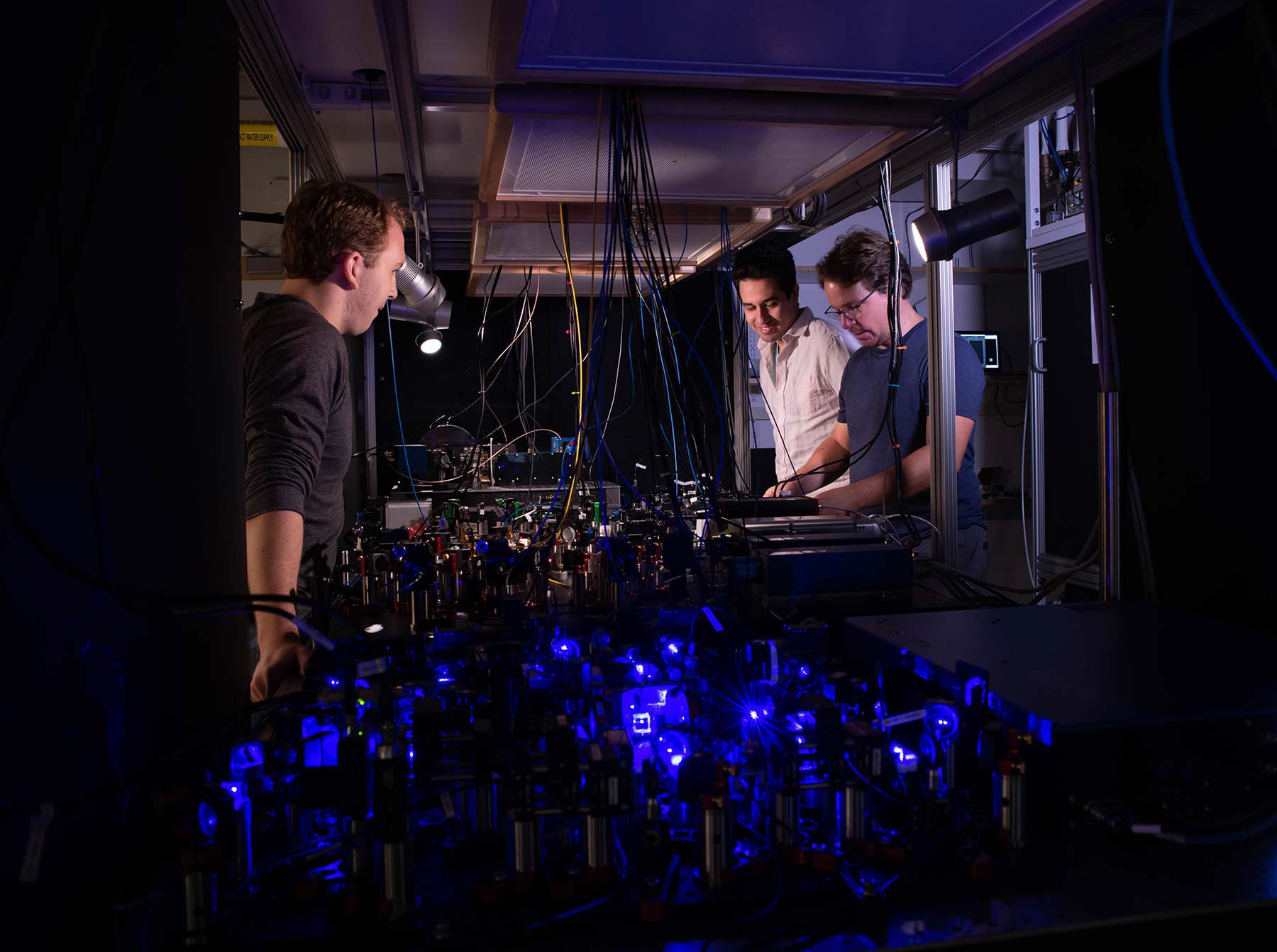 Adam Shaw, Ivaylo Madjarov and Manuel Endres work on their laser-based apparatus at Caltech.