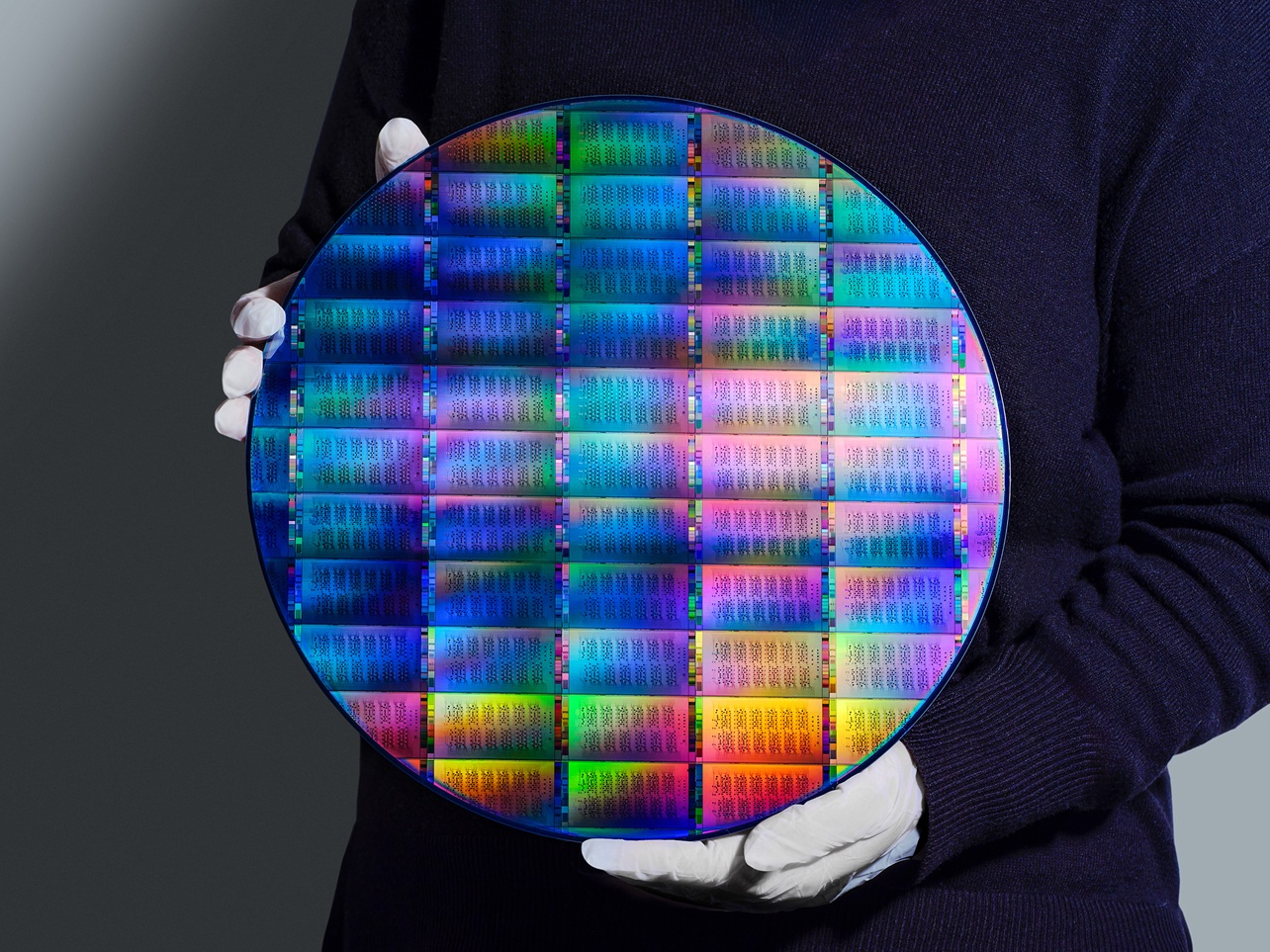 IBM researcher holding 300mm IBM Quantum Nighthawk wafer